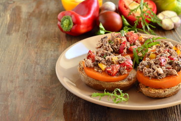 Bruschetta with tuna, tomatoes and sweet peppers, copy space
