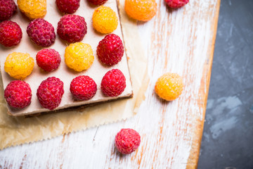 Fresh raspberry cheesecake on the rustic background. Selective focus. Shallow depth of field.