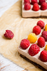Fresh raspberry cheesecake on the rustic background. Selective focus. Shallow depth of field.
