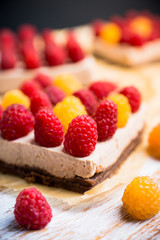 Fresh raspberry cheesecake on the rustic background. Selective focus. Shallow depth of field.