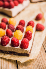 Fresh raspberry cheesecake on the rustic background. Selective focus. Shallow depth of field.