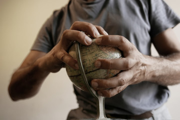 out of focus man holding earth globe