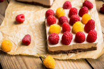 Fresh raspberry cheesecake on the rustic background. Selective focus. Shallow depth of field.