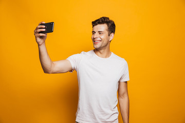 Portrait of a cheerful young man taking a selfie