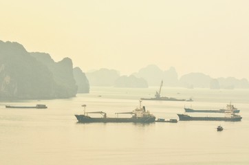Naklejka na ściany i meble View of Cargo Ships at Halong Bay During Sunrise in the Morning