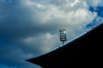 Light tower reflectors at a stadium during nightime.