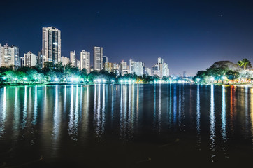 Photo of the Lago Igapo, Londrina - Parana, Brazil. View of the Igapo lake at night and the city, buildings on background. Leisure place, touristic destination of the city. - obrazy, fototapety, plakaty