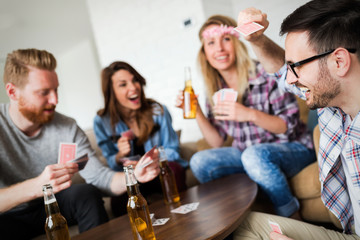 Cheerful friends having party and drinking beer