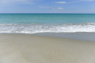 Fototapeta na wymiar Beach, waves and blue sky