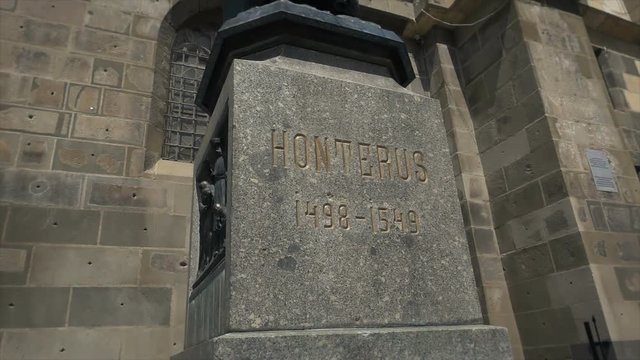 Footage of gothic architecture, Johannes Honterus statue, The Black Church in Brasov, Romania, tilt