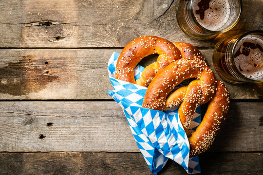 Oktoberfest concept - pretzels and beer on rustic wood background