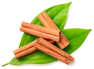 cinnamon sticks with fresh leaves isolatd on the white background, top view