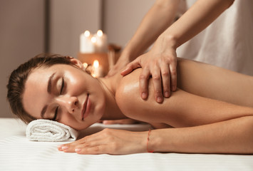 Serene young woman having massage