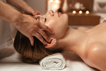 Beautiful young girl having face massage