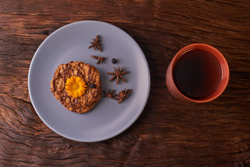 Tea and cookies on wood background. Concept of nice mood. isolated on black