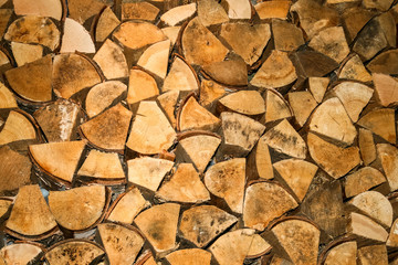 A wall made out of a stack of fire wood
