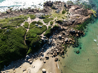  Aerial view of green islands on Brazilian beach with white sand and blue sea.