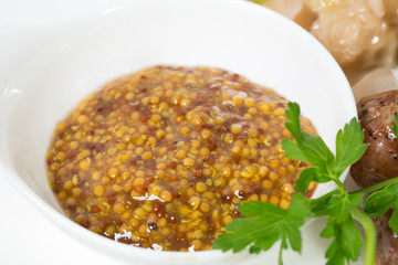 Bowl with mustard closeup.