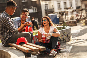 Group of friends hangout at the street.They drinking cold juice.Fast food.