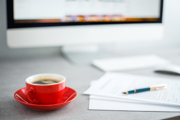 Cup of black coffee on the working desk of businessman