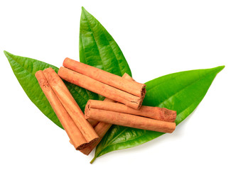 cinnamon sticks with fresh leaves isolatd on the white background, top view