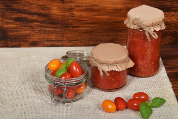 jar with tomato sauce for the winter, cherry tomatoes,