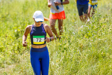 Young slim woman running trail race contest.