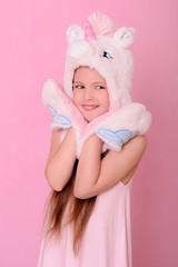  Caucasian beautiful little girl in a hat with unikorn