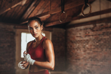 Female in shed preparing for boxing - obrazy, fototapety, plakaty