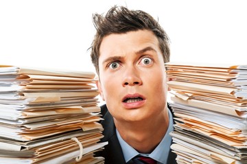 Portrait of a Surprised Employee Behind a Stack of Documents