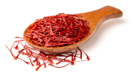 saffron thread in the wooden spoon, isolated on the white background.