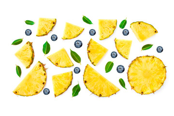 Flat lay of Sliced Pineapple, green leaves and berries isolated on white background. Fruit and Berry Pattern.