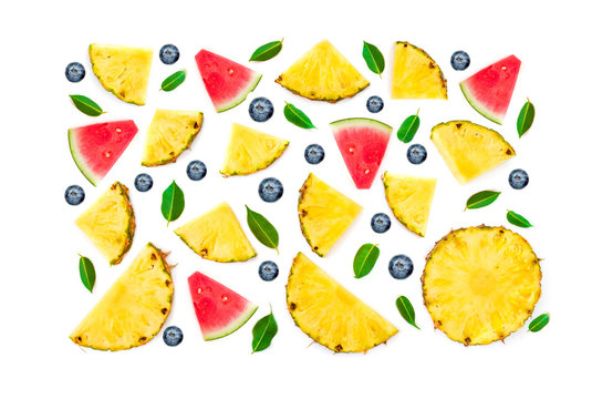 Flat lay Summer Collection of Sliced Pineapple, green leaves, watermelon and berries isolated on white background. Fruit and Berry Pattern. Top view.
