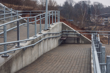brand new metal bridge with shiny rails and  concrete steps