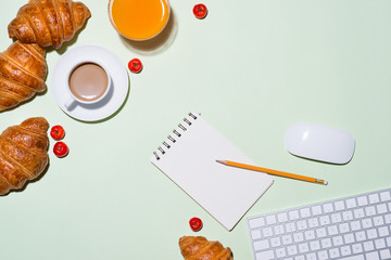 Breakfast with fresh croissants and orange juice, top view