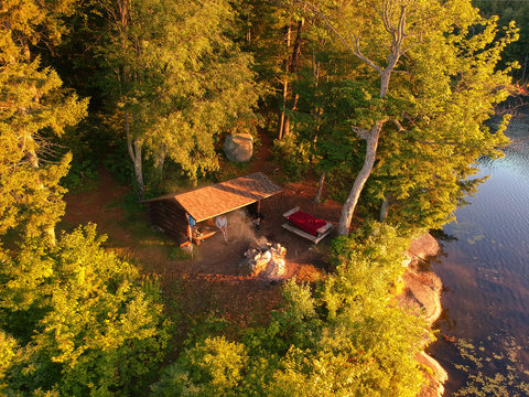 Aerial drone view of Lean to Campsite in the Adirondack mountains with a campfire burning. 