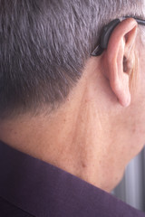 Naklejka premium Deaf man hearing aid ear