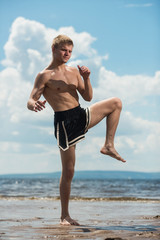 Fototapeta na wymiar athlete warm up before training against the sea