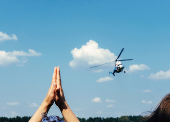 rescue helicopter,  hands ask for help,