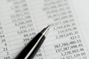 Investment, financial report statistic concept, close-up of black pen on printed stock exchange data price number or valuation table