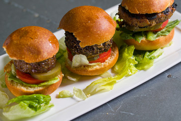 Close up shot of 3 sliders on a plate