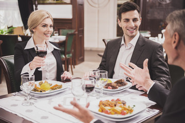 Team of Businesspeople Having Lunch in Restaurant.