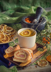 cup of tea, a biscuit, berries and dried fruits on the table. Vintage style