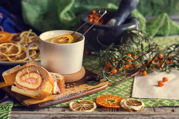 cup of tea, a biscuit, berries and dried fruits on the table. Vintage style