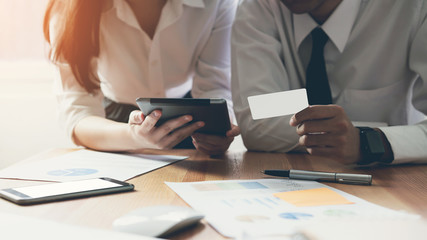 business team working with startup project in coworking. Using marketing plans on laptop, technology and documents.