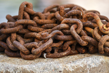 Old and rusty harbor chains.