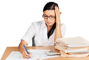 Businesswoman sitting at the table with many papers on