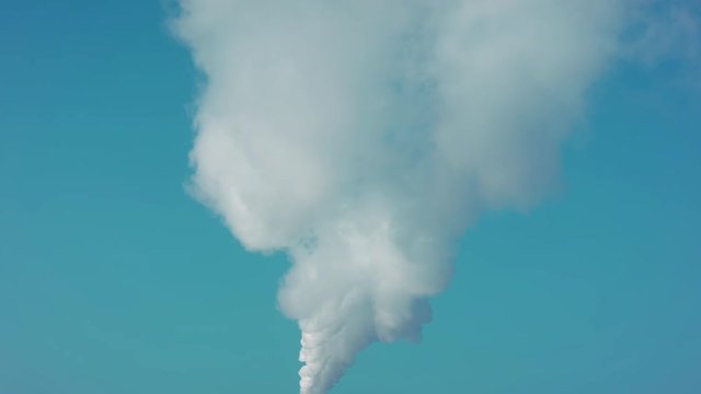 The pipe of the plant, amazing sky, produces clouds of smoke. Futa of smoke