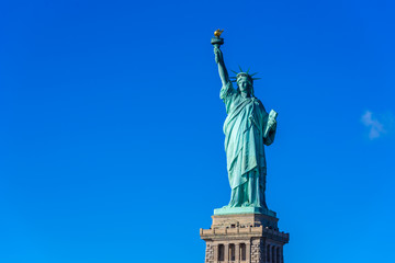Fototapeta na wymiar The statue of Liberty at a sunny day with blue sky, New York City, USA