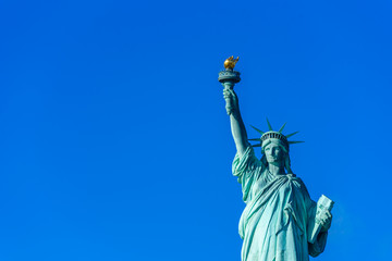 Fototapeta premium The statue of Liberty at a sunny day with blue sky, New York City, USA